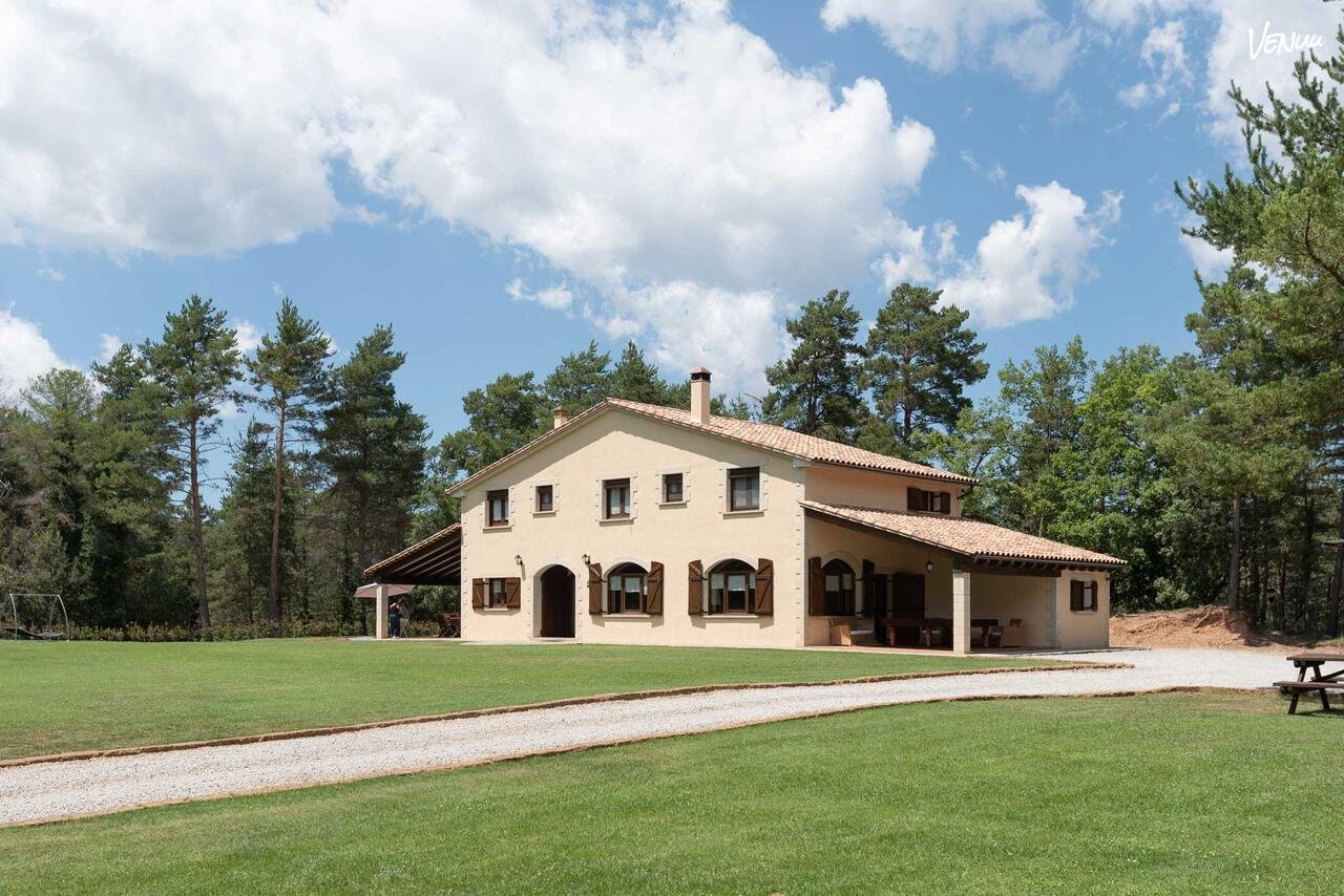Rustic outdoor wedding venue surrounded by countryside landscapes.